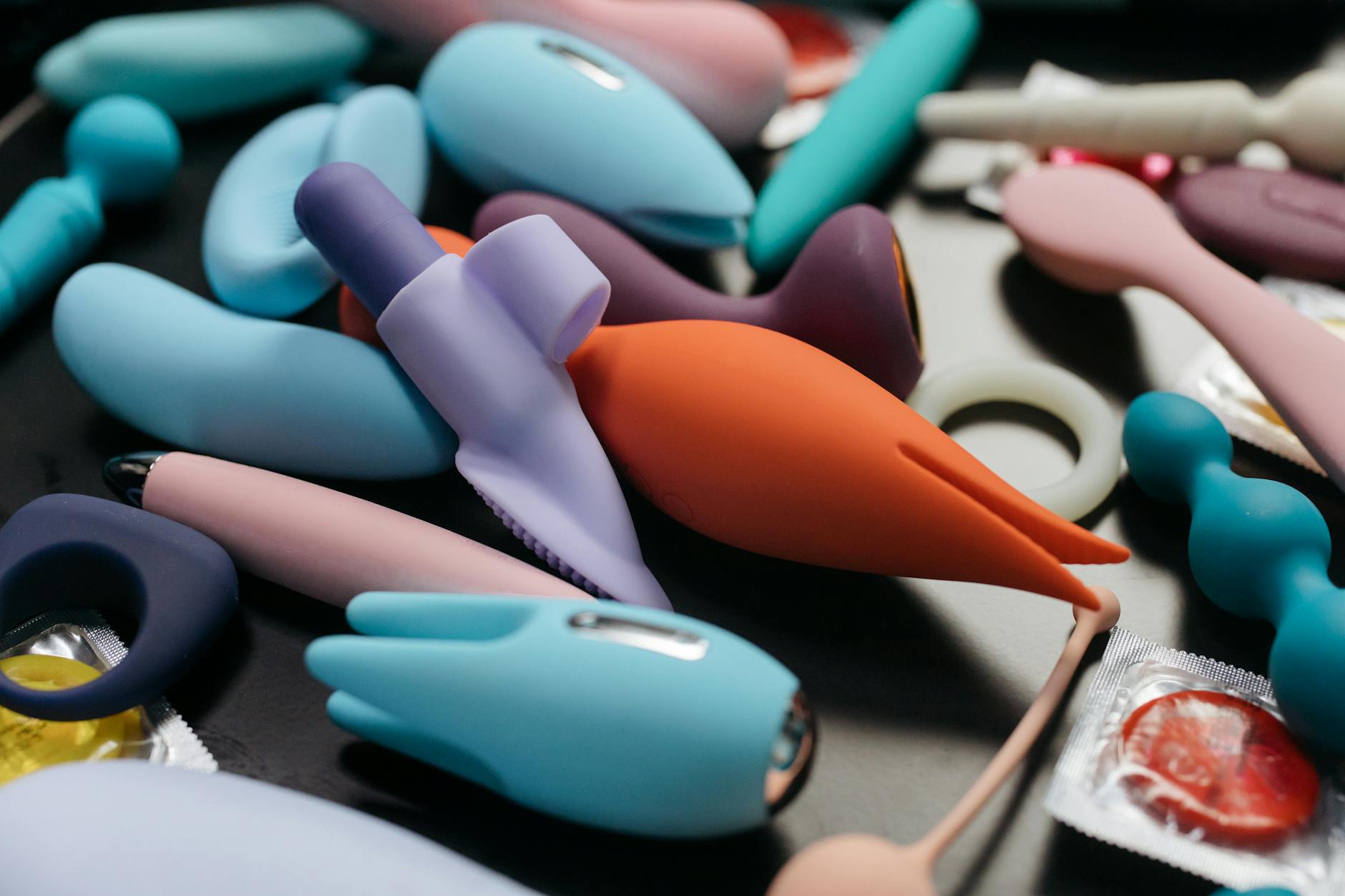 An array of vibrant lemon clitoral vibrators and other adult toys in a close-up view.