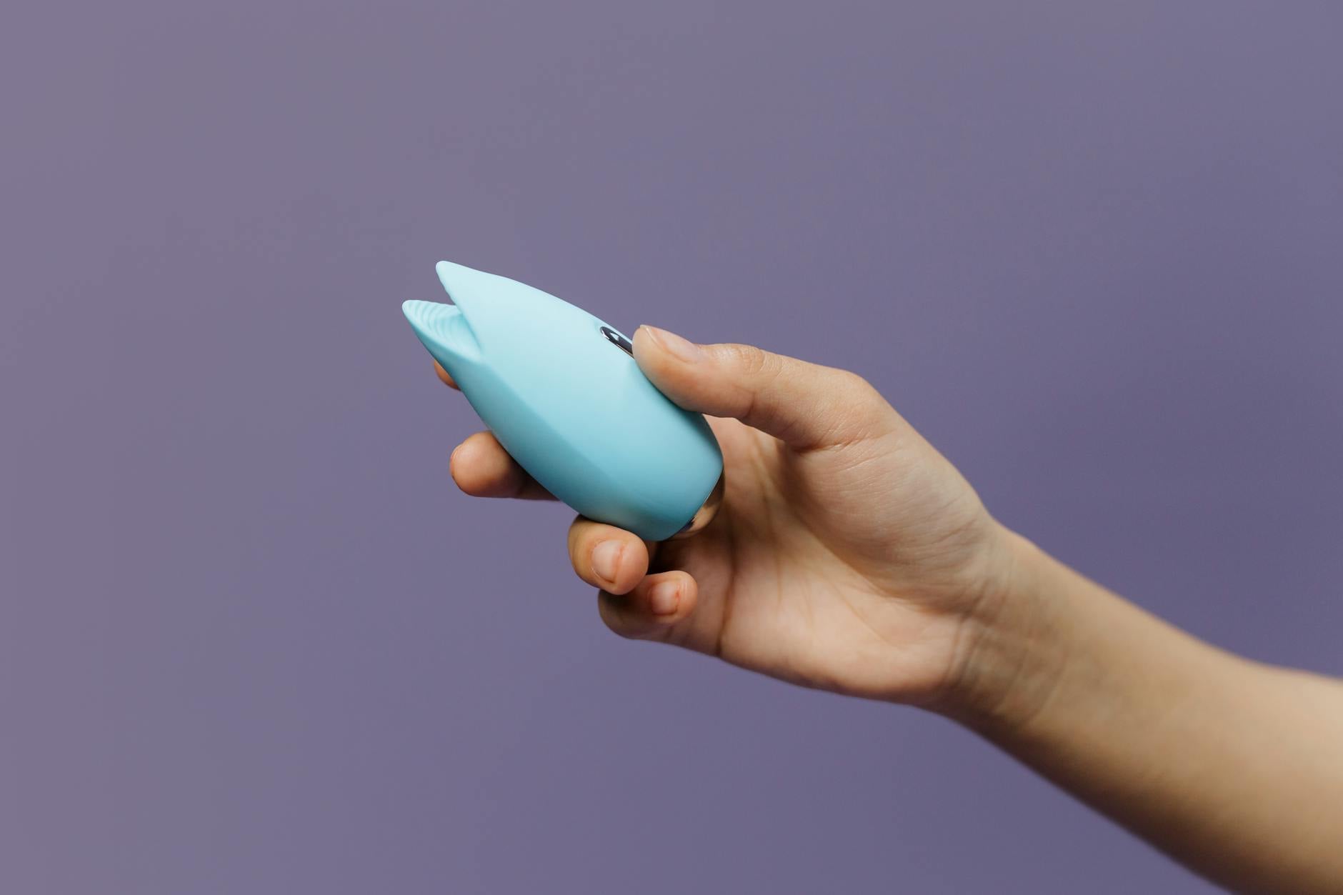 A yellow lemon clitoral vibrator on a bright yellow background, representing rekindled desire