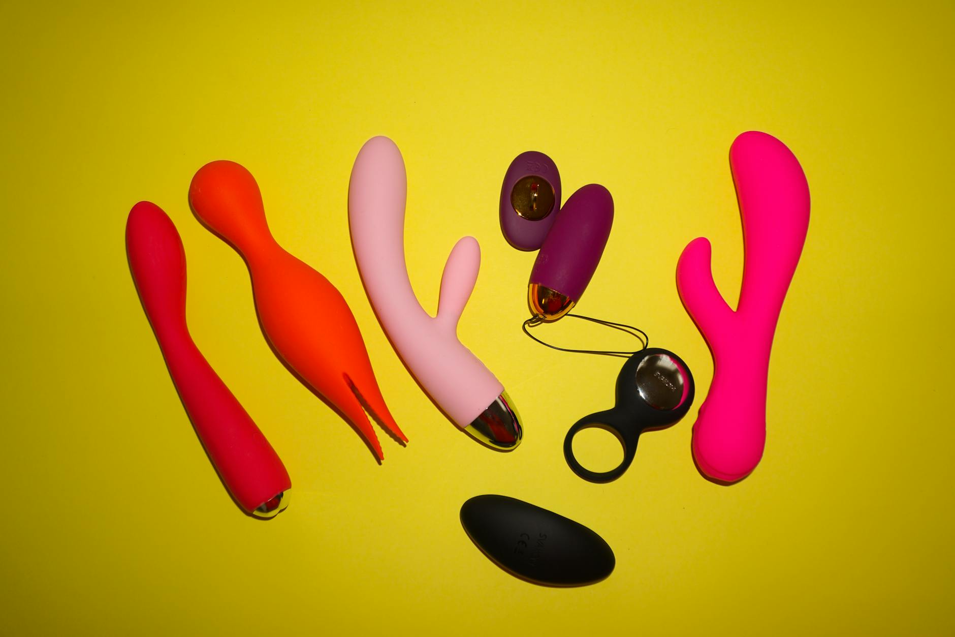 Woman holding silicone vibrators in contemplative reflection