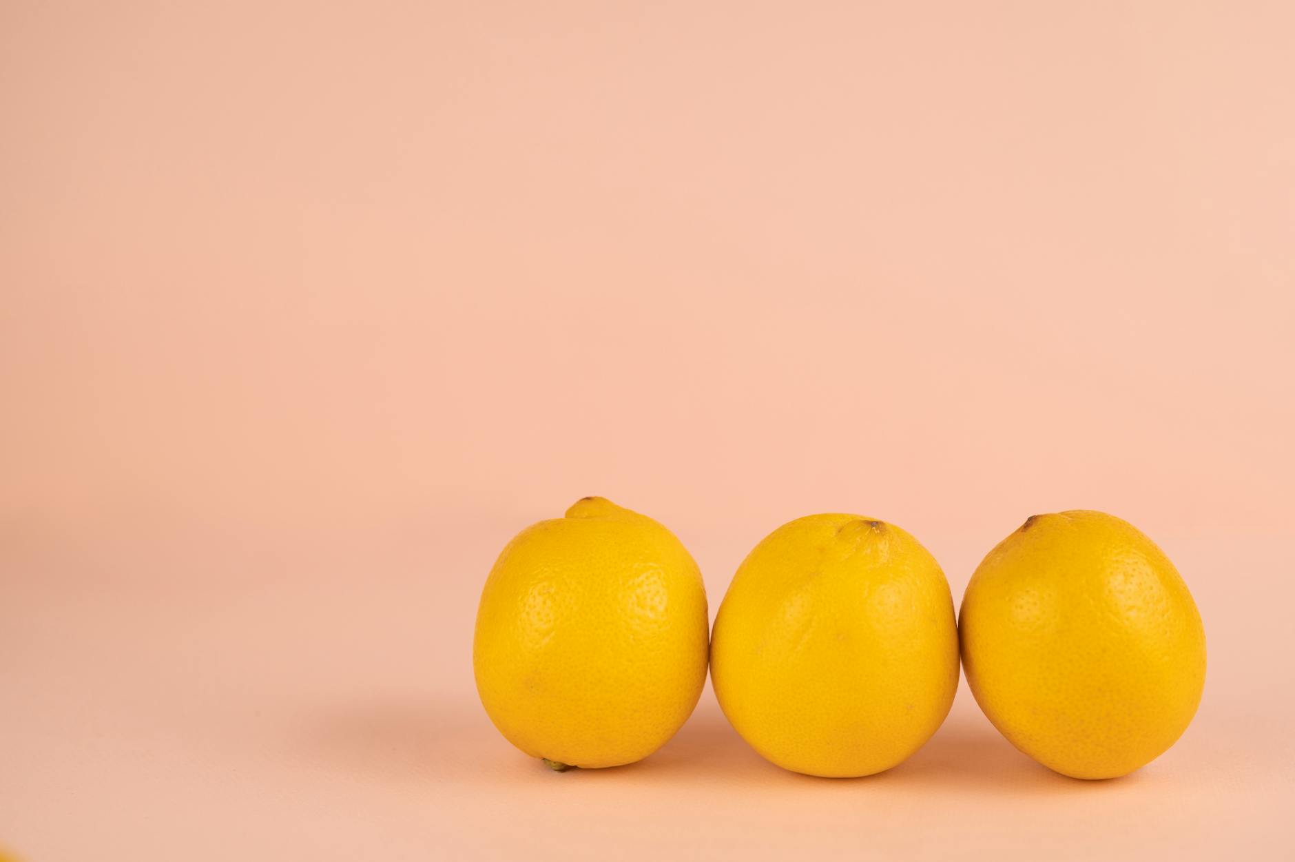 Bright ripe lemons on a pastel background, symbolizing fresh approach to pleasure without pressure